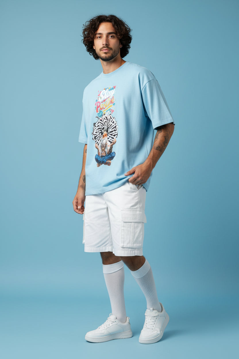 ZotRage baby blue heavyweight cotton oversized t-shirt featuring a graphic of a meditating man with Stay Positive text
