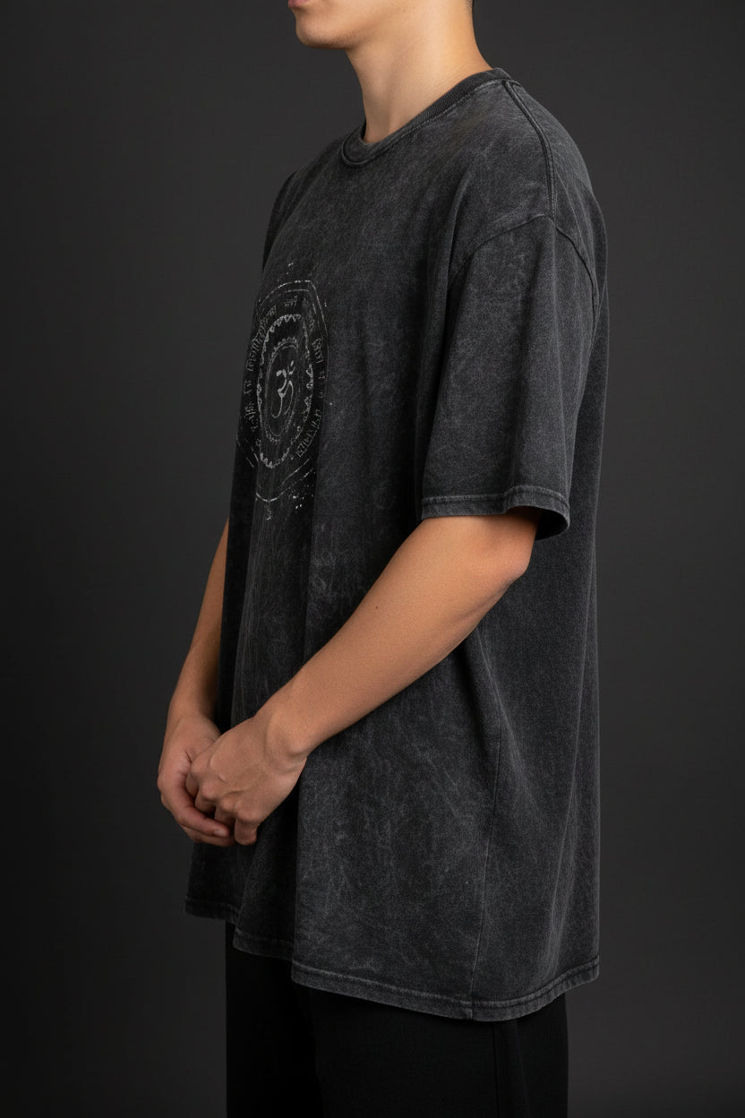 ZotRage black acidwash oversized t-shirt featuring a circular Om symbol graphic print on the chest.