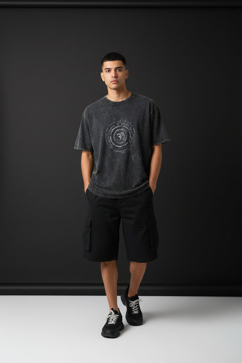 ZotRage black acidwash oversized t-shirt with a circular white Om symbol graphic print on the chest.
