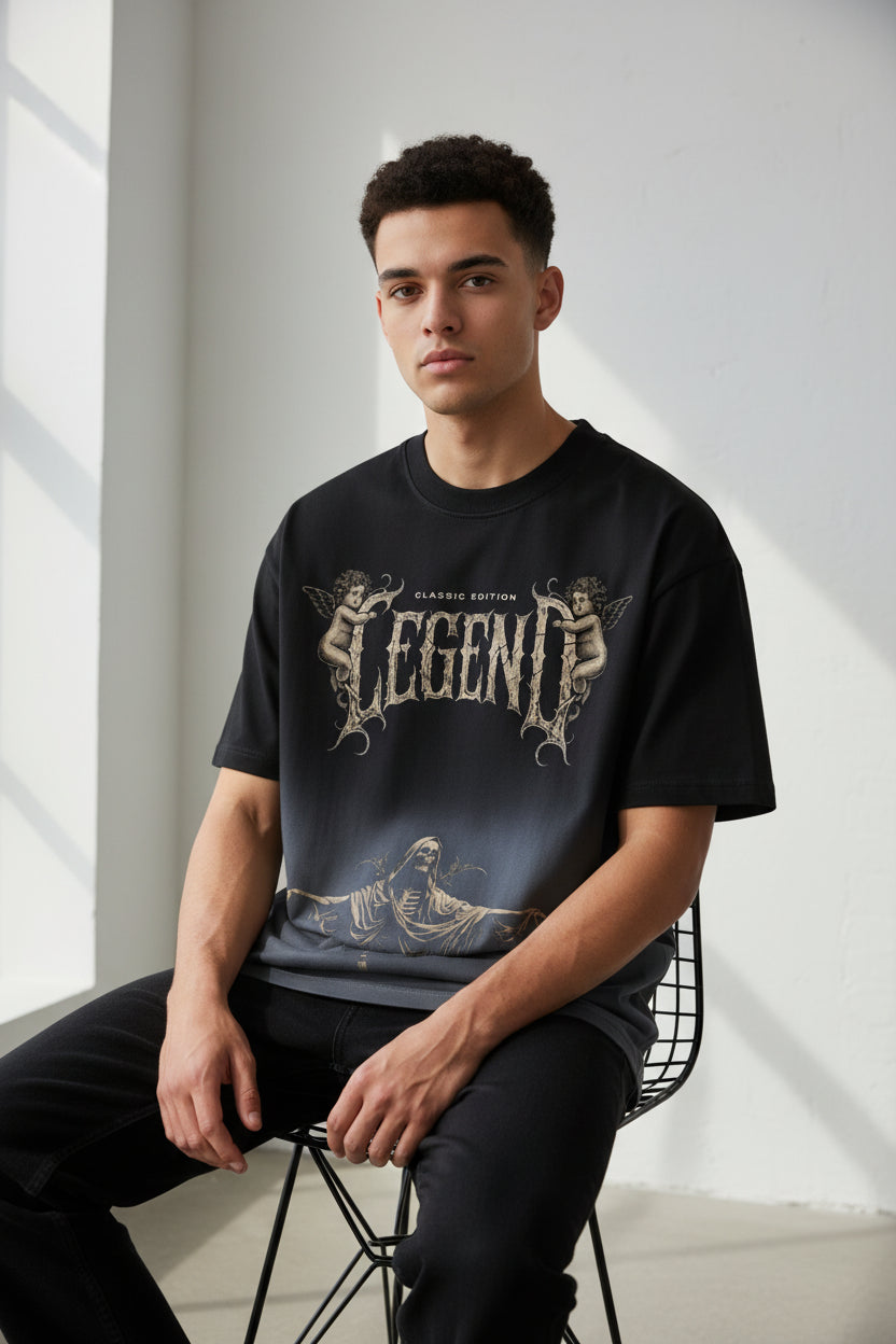 ZotRage black ombre boxy fit t-shirt featuring a vintage-style Legend graphic with cherubs and a grim reaper figure.