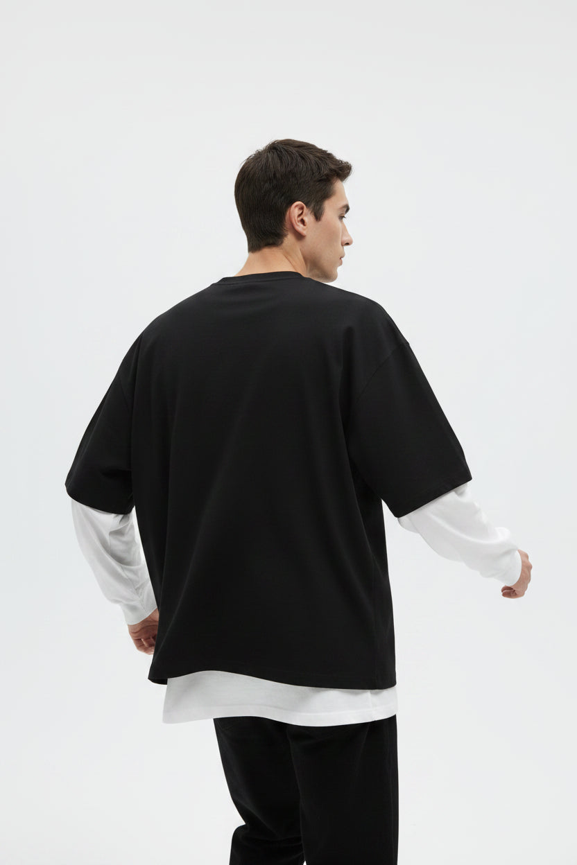ZotRage oversized long sleeve tee in black with white waffle-knit sleeves and a relaxed, layered aesthetic.