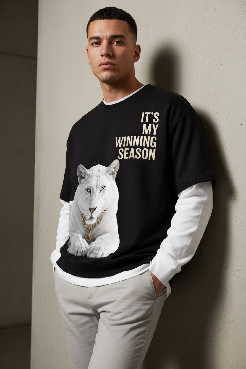 ZotRage black oversized waffle-knit tee with white long sleeves, featuring a white lion graphic and text print.
