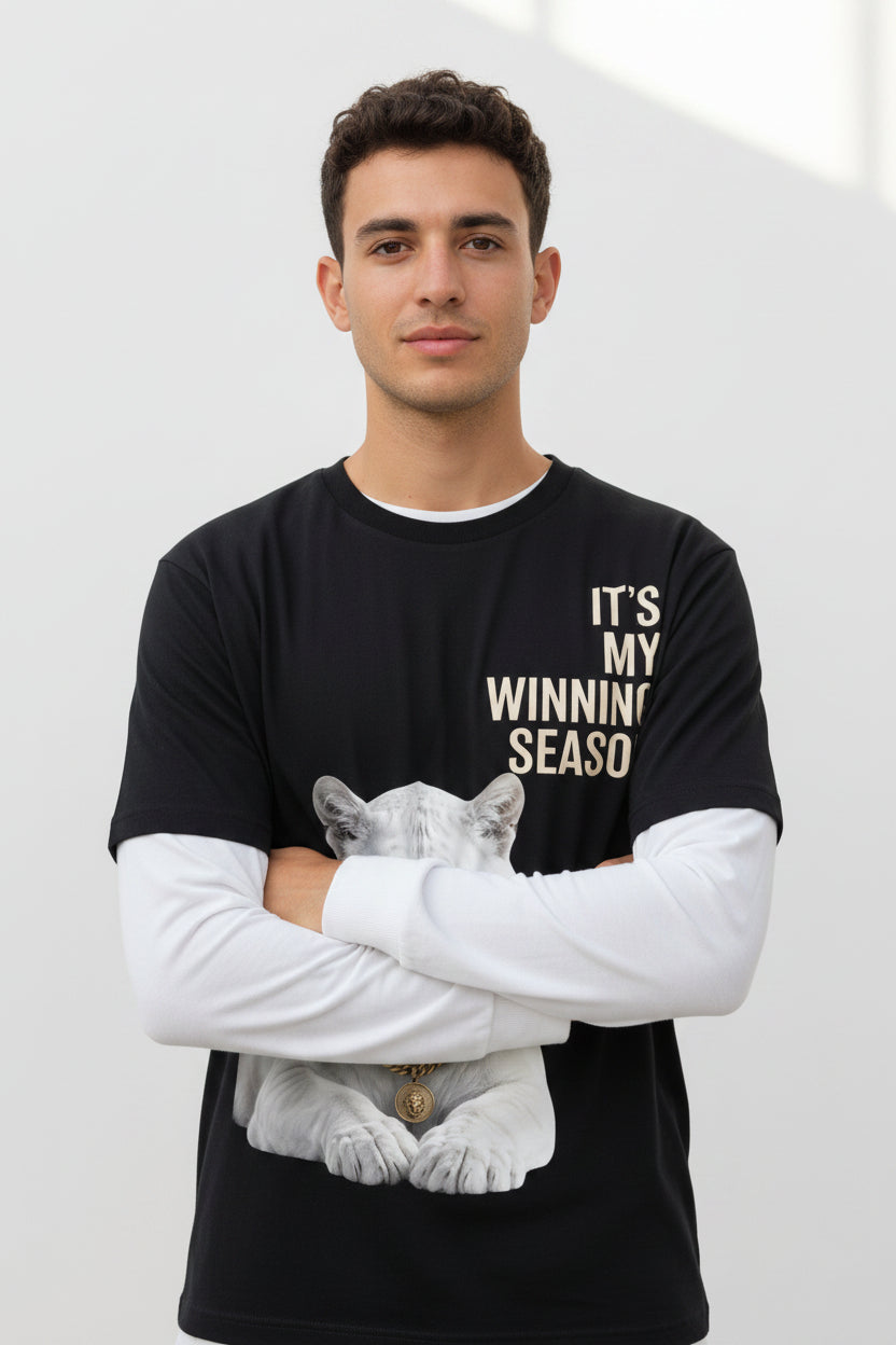 ZotRage oversized black waffle-knit tee with white sleeves, featuring a white lion graphic and winning season text.