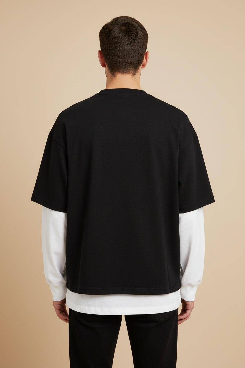 ZotRage oversized long sleeve tee featuring a black body and contrasting white sleeves in a textured waffle-knit fabric.
