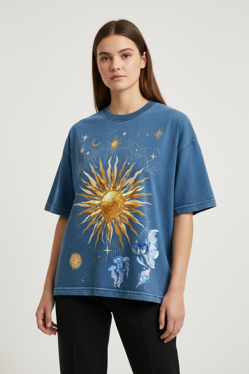ZotRage blue denim wash boxy fit t-shirt featuring a celestial sun, moon, and jellyfish graphic print.