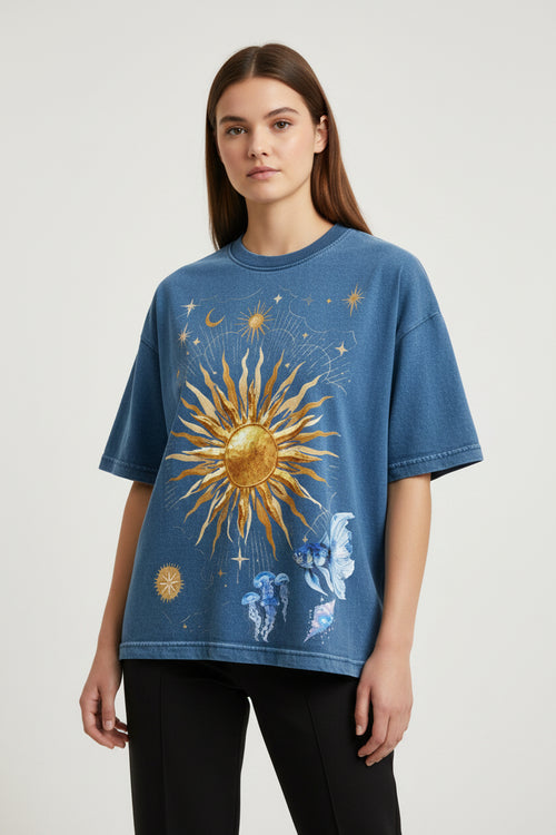 ZotRage blue denim wash boxy fit t-shirt featuring a celestial sun, moon, and jellyfish graphic print.