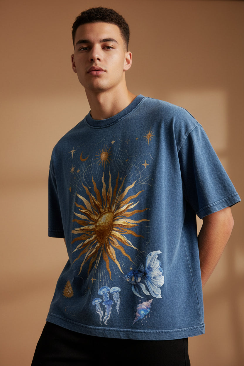 ZotRage blue denim wash boxy fit t-shirt featuring a celestial sun and jellyfish graphic print on the front.