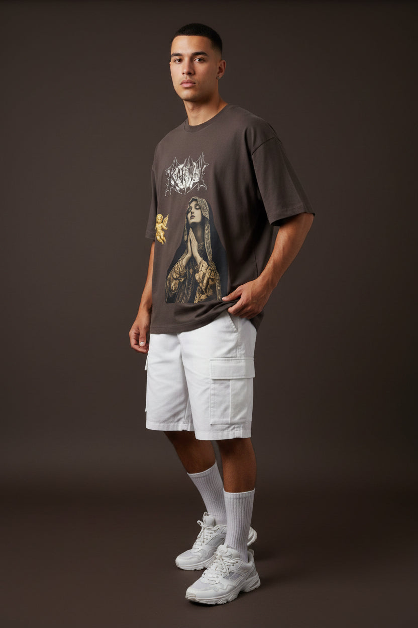 ZotRage brown oversized t-shirt featuring a Karma metal-style logo, a praying woman graphic, and a gold cherub.
