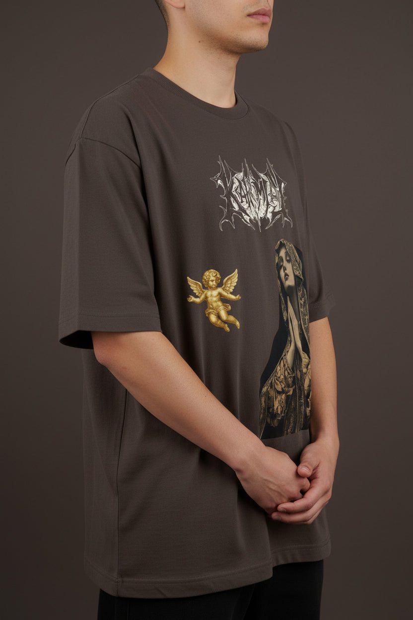 ZotRage brown oversized t-shirt featuring a Karma metal-style logo, a praying woman graphic, and a gold cherub.