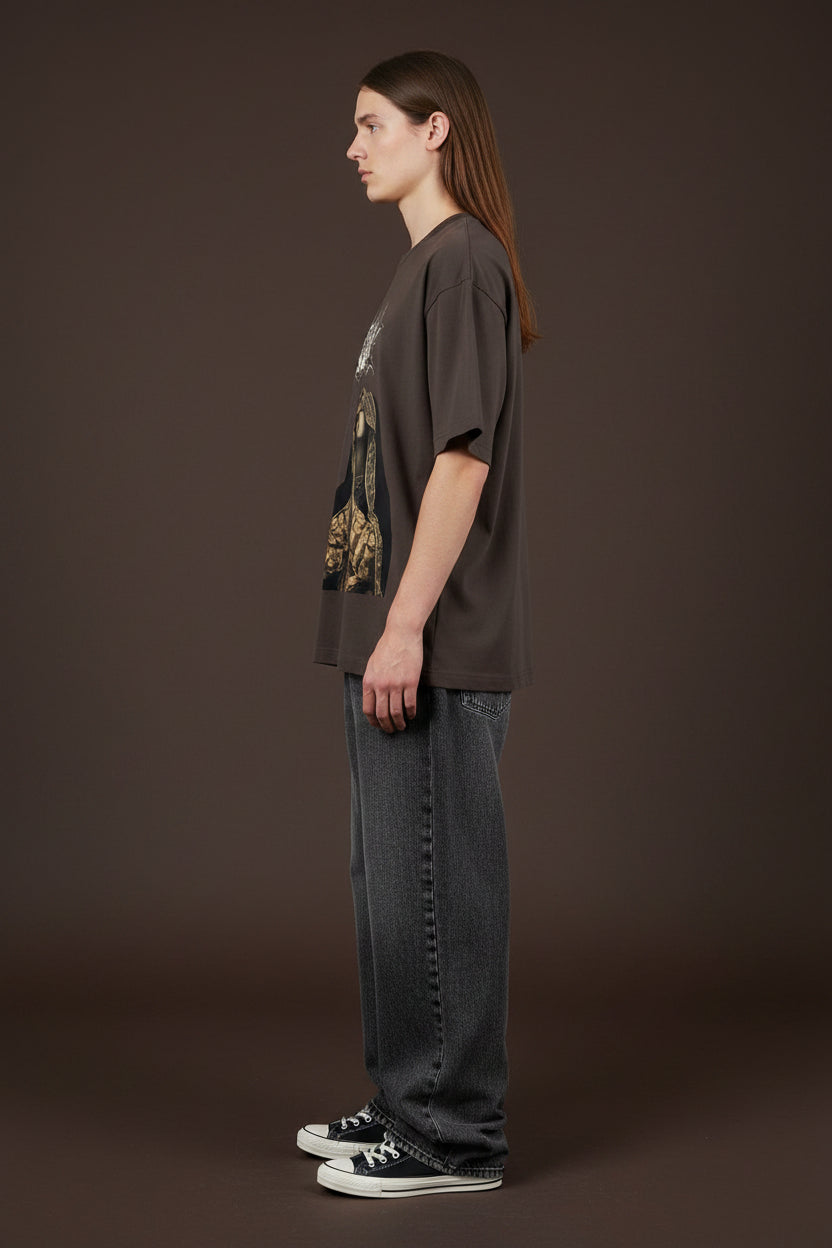ZotRage brown oversized t-shirt featuring a Karma metal-style logo, a praying woman graphic, and a gold cherub.