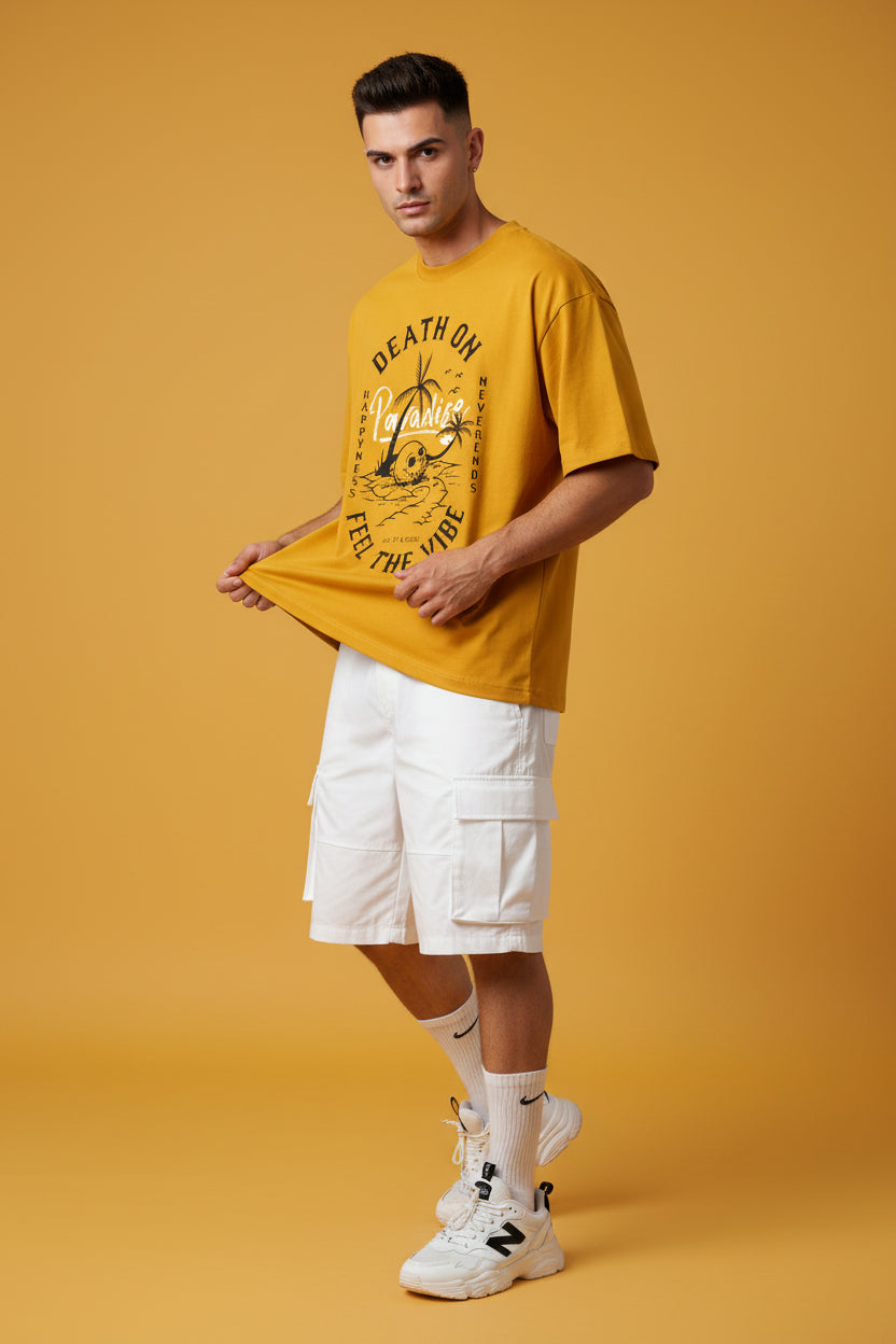 ZotRage golden yellow oversized cotton t-shirt featuring a black graphic print of a skull, palm tree, and text.