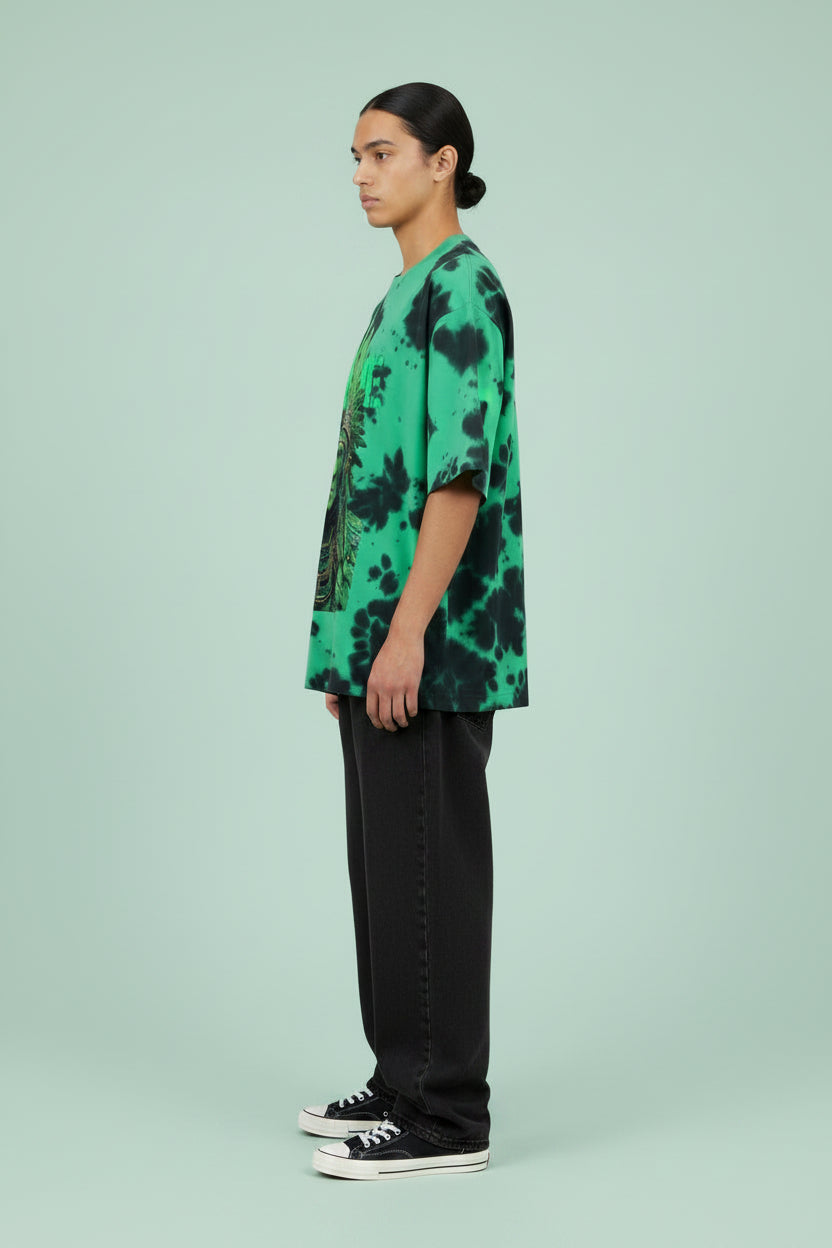 ZotRage oversized unisex t-shirt in green and black tie-dye with a detailed graphic print of a tribal warrior.