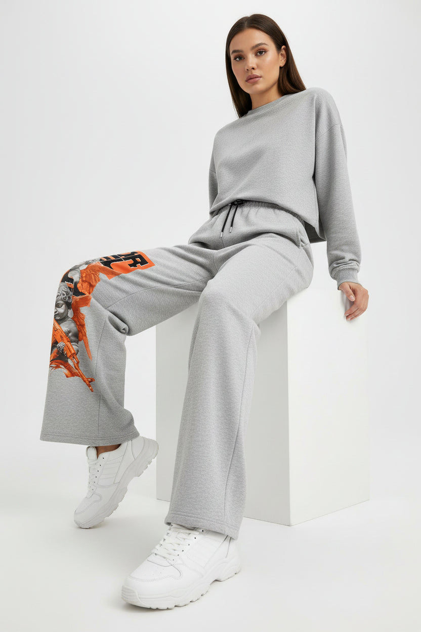 ZotRage grey cotton joggers featuring a graphic print of a cherub with an orange rifle and bold black text