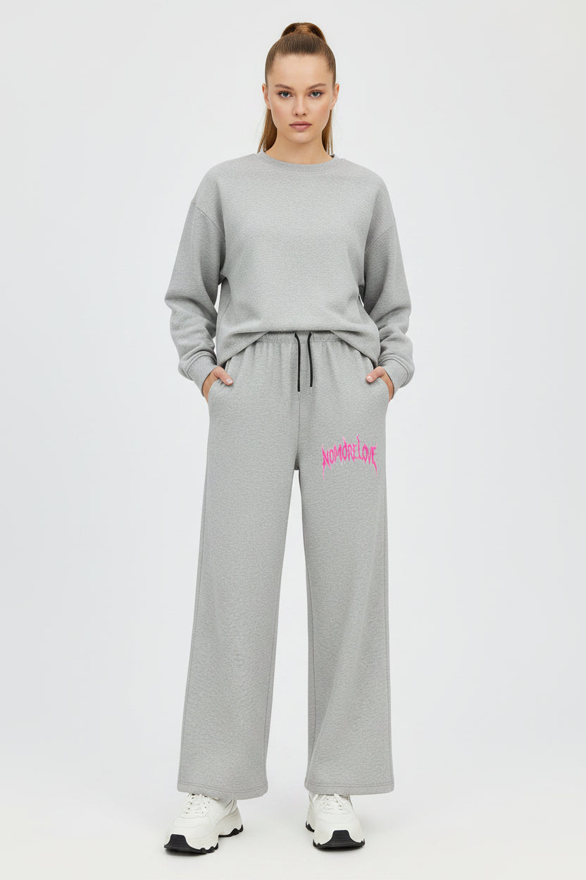 ZotRage grey cotton joggers featuring a wide-leg fit and pink No More Love graphic print on the hip