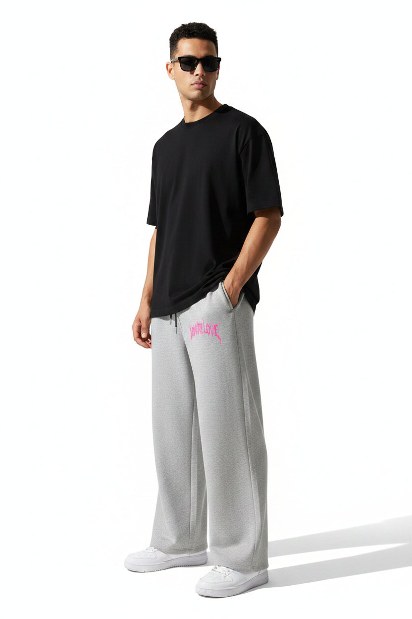 ZotRage grey cotton joggers featuring a wide-leg fit, elastic drawstring waist, and pink No More Love graphic print.