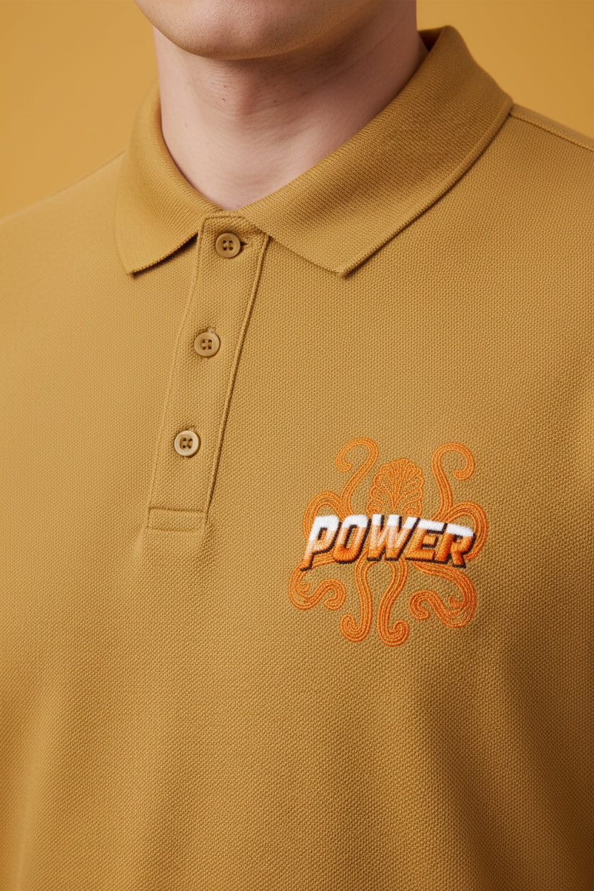 ZotRage mustard yellow cotton polo shirt with a textured Airtex finish and a Power graphic on the chest