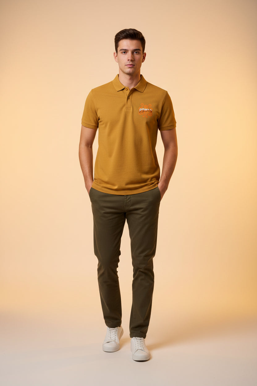 ZotRage mustard yellow cotton polo shirt with a textured Airtex finish and a Power logo graphic on the chest.