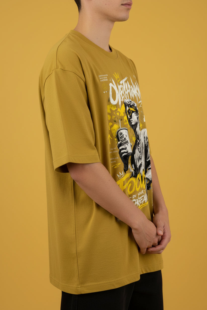 ZotRage mustard yellow oversized cotton t-shirt with graphic print of a statue and motivational text