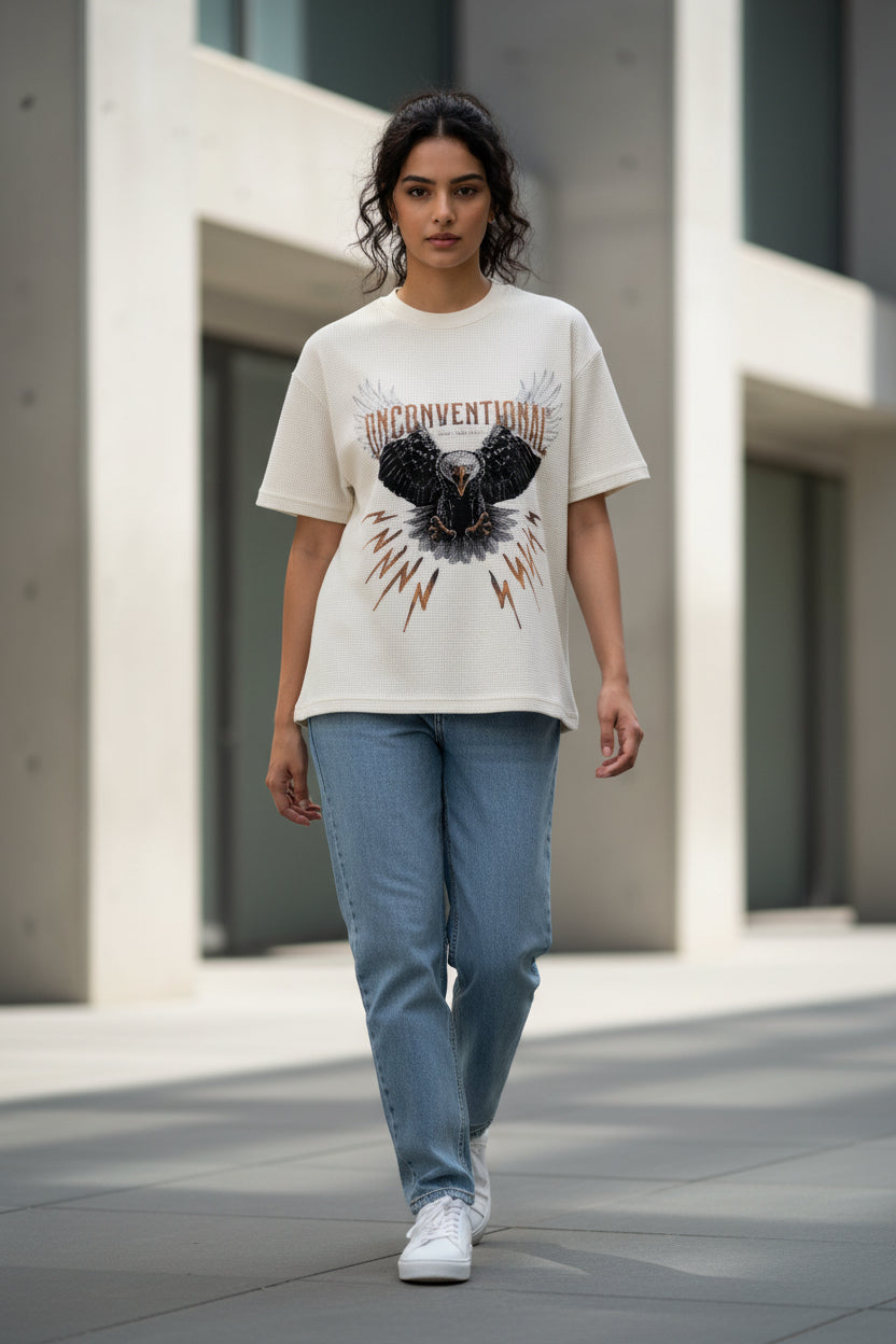 ZotRage off-white waffle knit cotton t-shirt featuring a graphic eagle print and Unconventional text on the front.