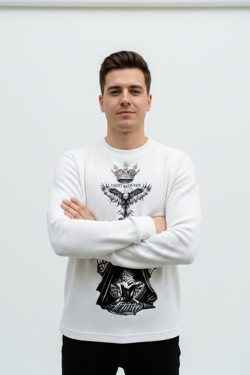 ZotRage off-white waffle knit long-sleeve shirt with a graphic print of a nun, eagle, and crown on the front.
