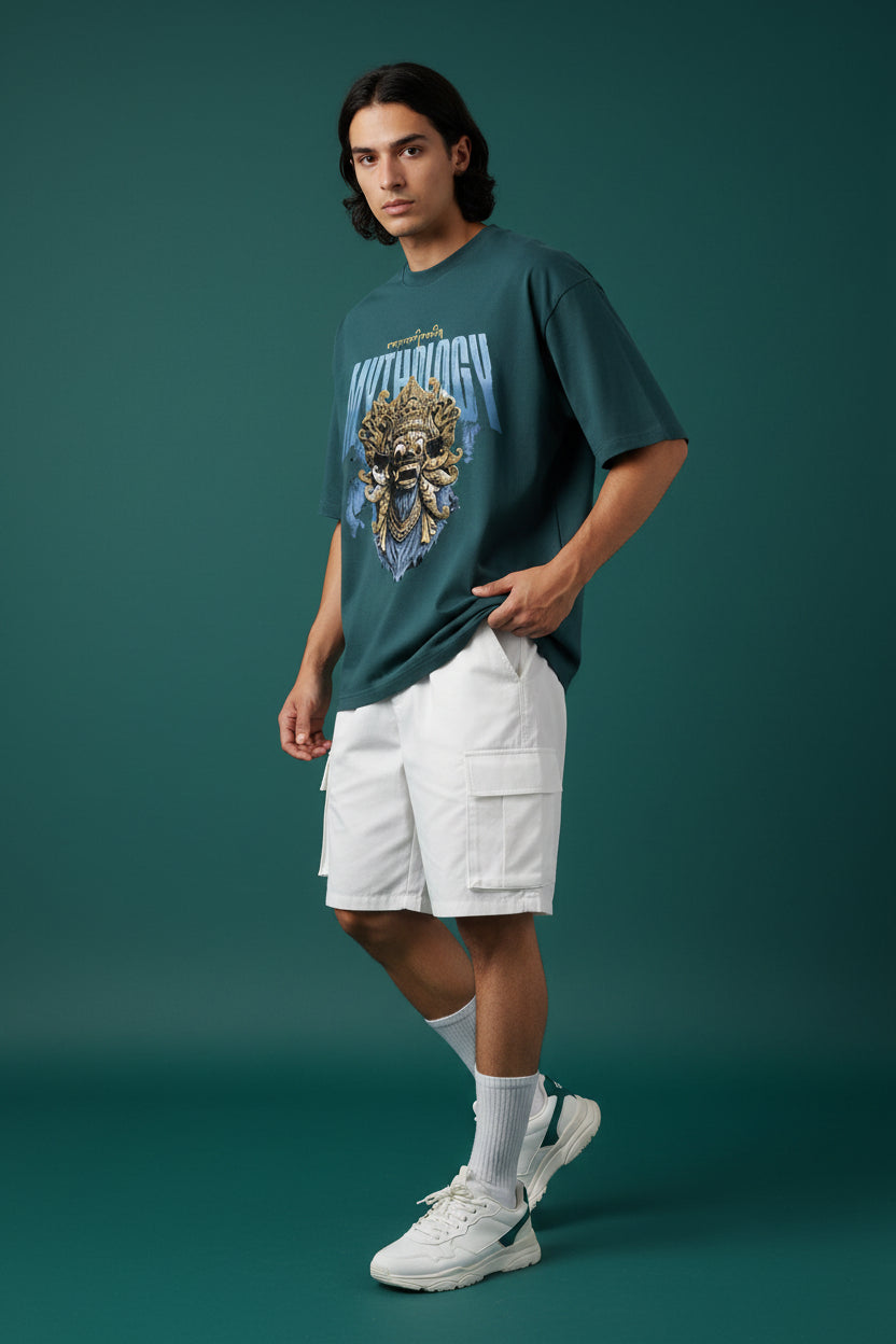 ZotRage petrol blue heavyweight cotton oversized t-shirt featuring a gold Balinese mask graphic and Mythology text