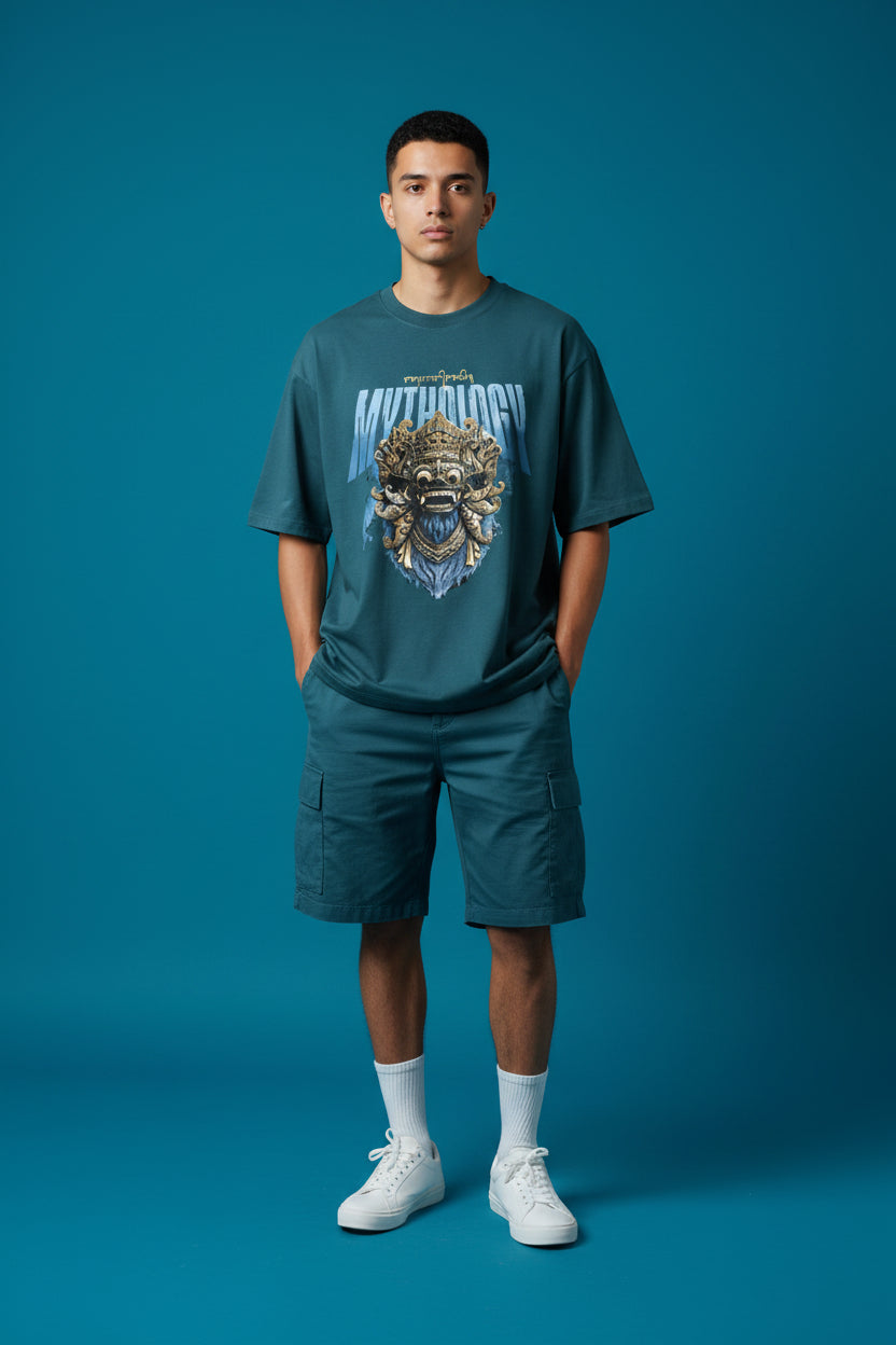 ZotRage petrol blue heavyweight cotton oversized t-shirt featuring a detailed gold Balinese mask graphic print