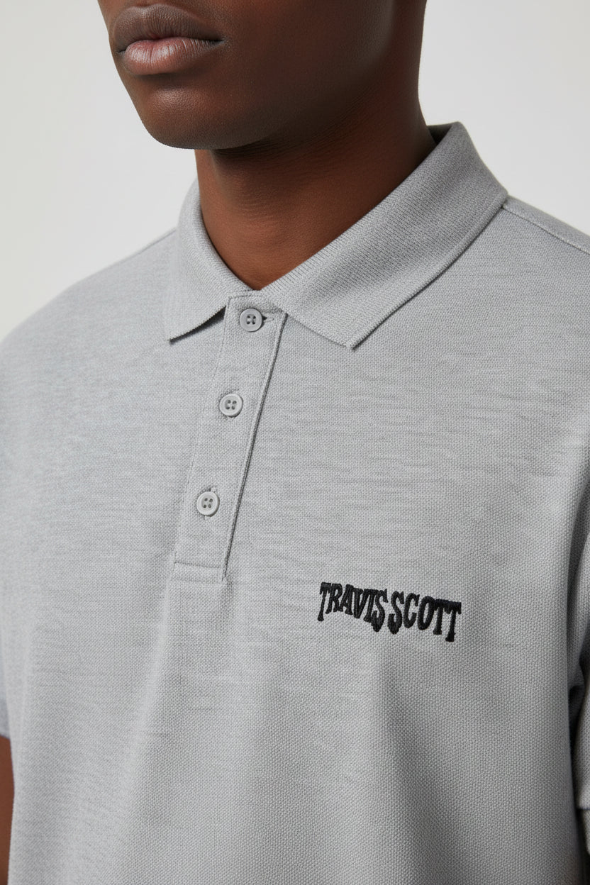 ZotRage Travis Scott grey melange polo shirt in 100% cotton Airtex fabric with a structured collar and black logo.