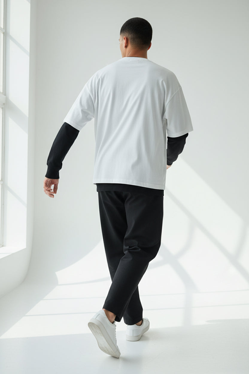 ZotRage oversized waffle-knit tee in off-white with contrasting black long sleeves, back view.