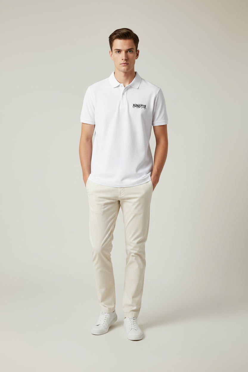 ZotRage white cotton Airtex polo shirt with a textured finish, structured collar, and black Monster logo embroidery.