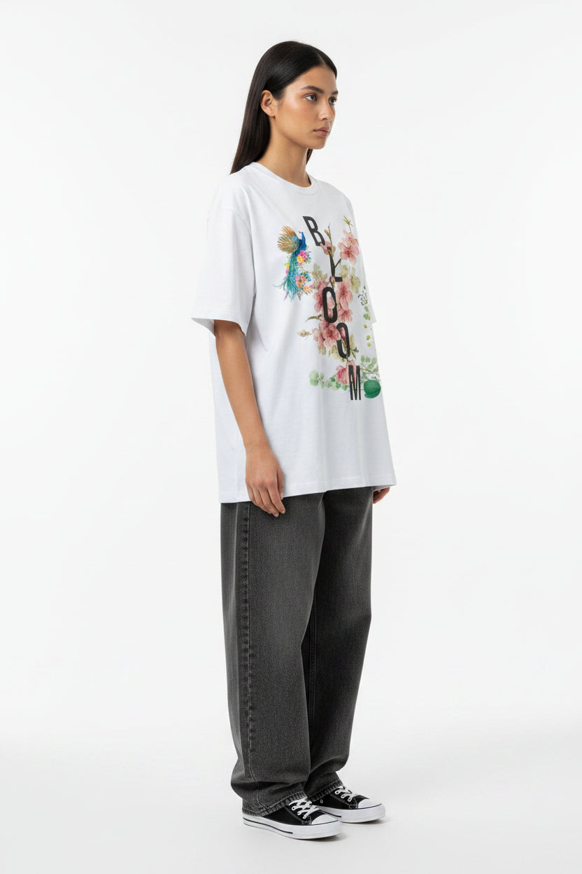 ZotRage white heavyweight cotton oversized t-shirt featuring a floral Bloom graphic with a peacock illustration.