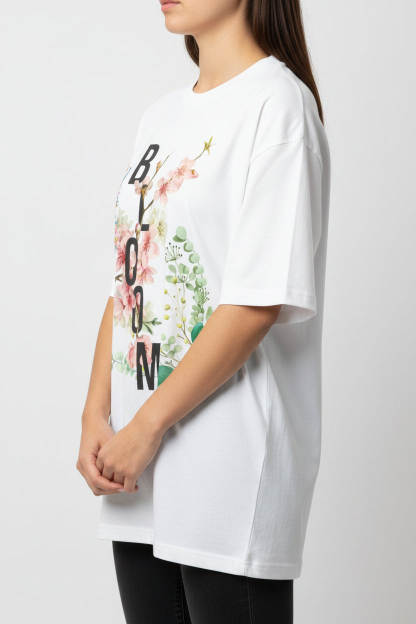 ZotRage white oversized cotton t-shirt featuring a floral Bloom graphic with a peacock and botanical elements.