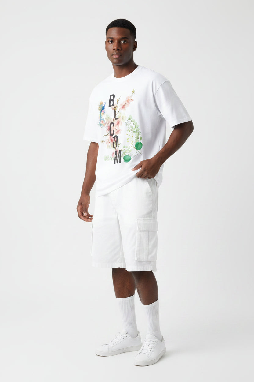 ZotRage white oversized cotton t-shirt featuring a floral Bloom graphic with a peacock and botanical elements.