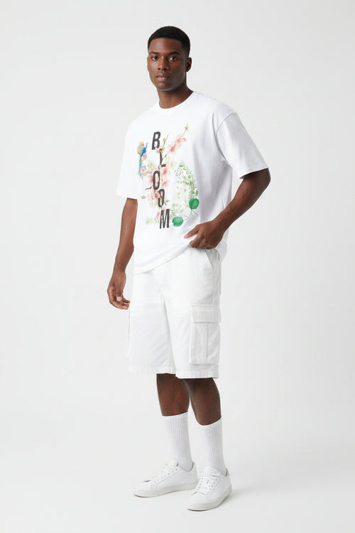 ZotRage white oversized cotton t-shirt featuring a floral Bloom graphic with a peacock and botanical elements.