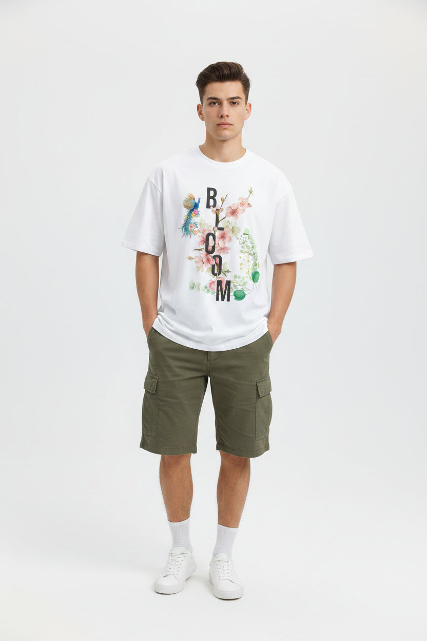 ZotRage white oversized cotton t-shirt featuring a floral Bloom graphic with a peacock and botanical elements.