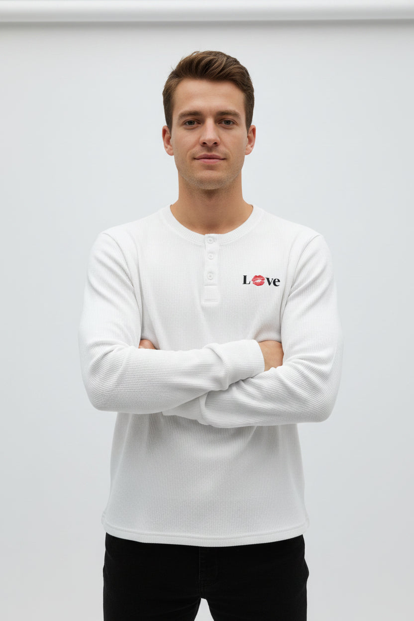 ZotRage off-white waffle knit henley shirt with long sleeves and a red lip print detail in the word Love